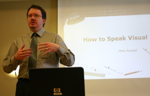 Mike Russell speaking at a luncheon on "How to speak Visual".